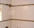 Master bath tub surround with glass block and decorative accent
